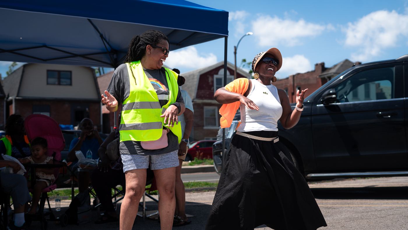 Volunteers dancing at a community charity drive