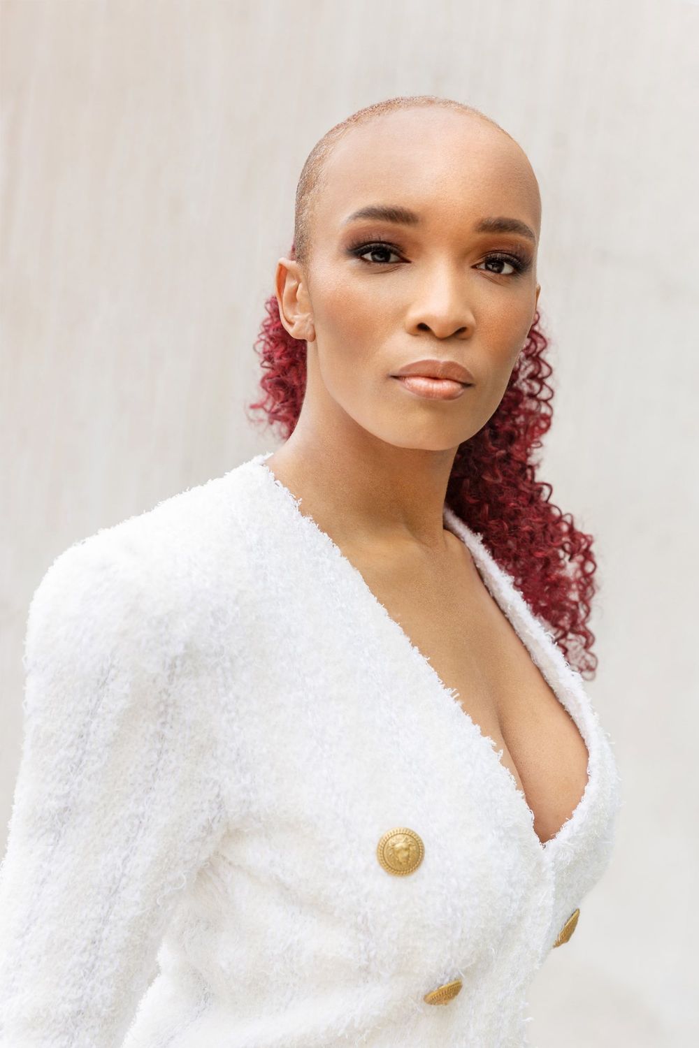 Portrait of Florie Naomi in a white jacket with gold buttons